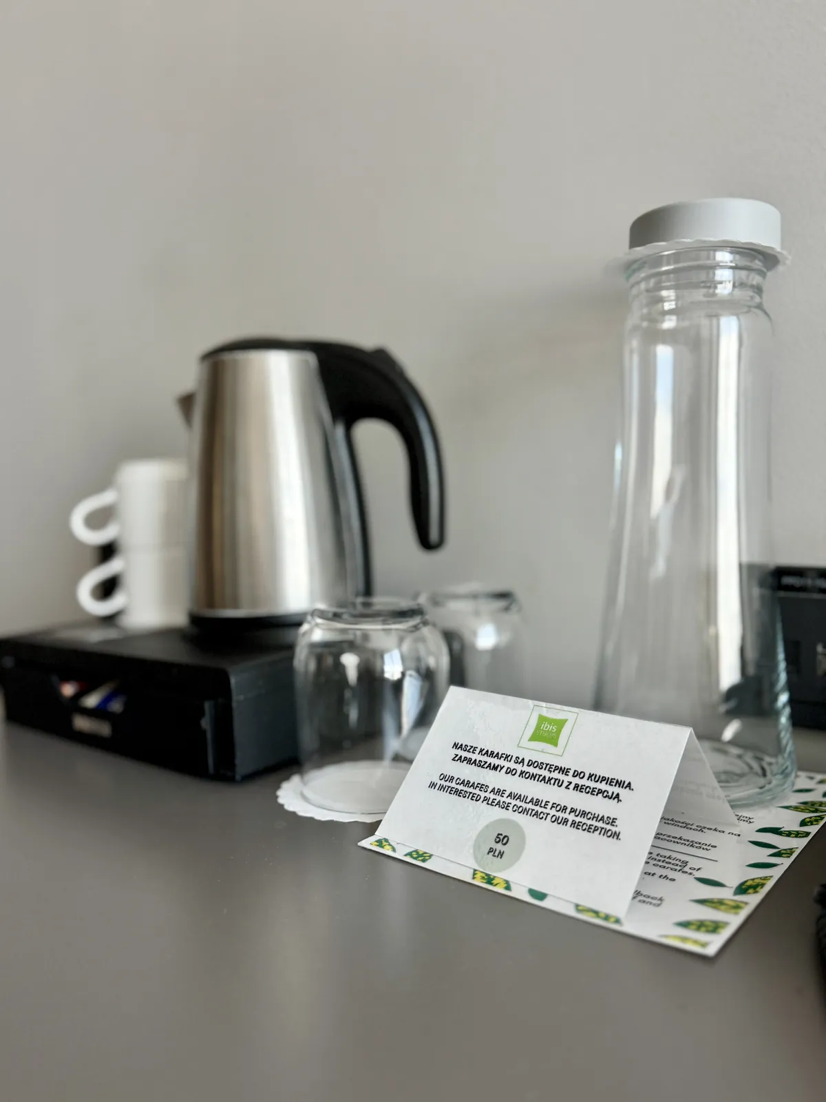 Coffee and tea set in the room — kettle, cups, glasses and a glass water carafe