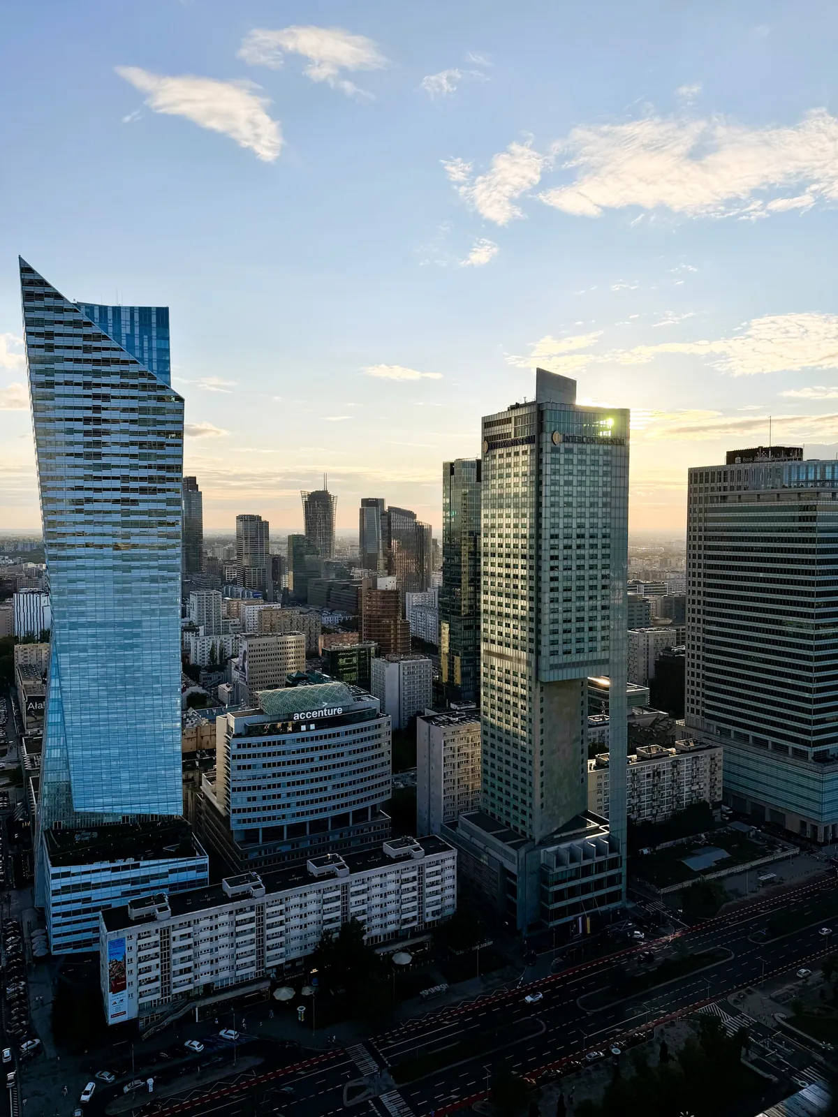 Panorama of central Warsaw at sunset from the Palace of Culture and Science viewing terrace — Złota 44 and the towers towards Rondo ONZ